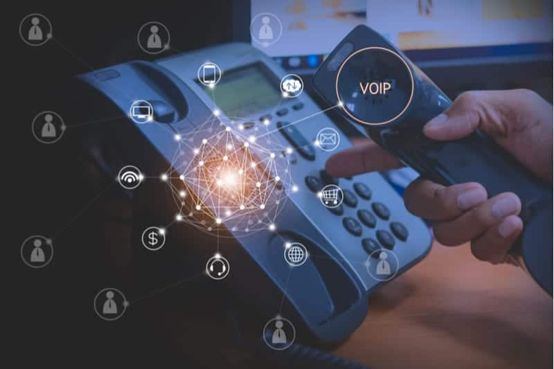 Person dialing a phone number on a VOIP phone
